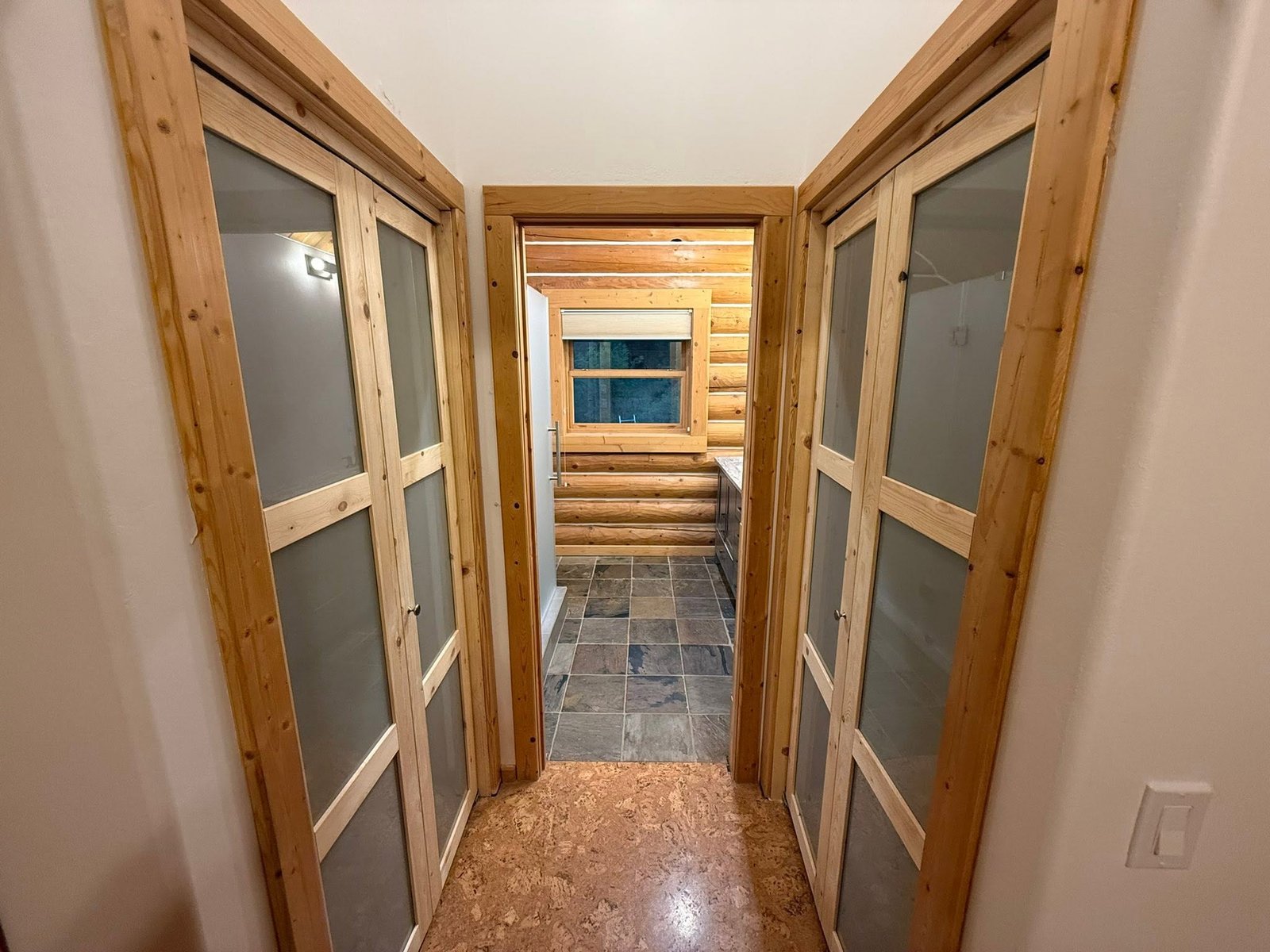 Finished hallway and log cabin bathroom